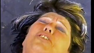 Watch an older woman grab his nuts and suck his dick in public